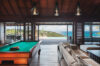 Game room with billiard table and open view to infinity pool and sea at luxury villa st barths