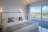 Bright bedroom with king bed and terrace access at vacation rental st barts offering serene ocean views.