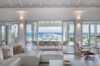 Bright living room with panoramic ocean view at luxury st barts villa rental featuring modern coastal design