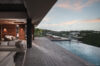 Open-air living area beside infinity pool at private St Barts villa rental overlooking the hills at dusk