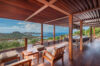 Covered wooden terrace at luxury st barts villa with lounge seating and panoramic Caribbean view