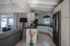Modern kitchen with stainless steel appliances and sea view adjoining living room in a St Barts villa rental