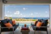 Terrace lounge with ocean views, black sofas and orange cushions at a luxury villa in St Barts