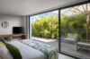 Tranquil bedroom with garden terrace and modern design at private villa rental in St Barths.