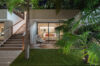 Evening view of modern villa with illuminated terrace and tropical garden in St Barths luxury rentals